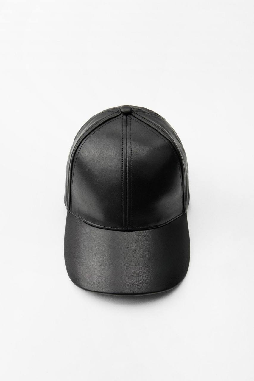 Black leather cap on a white background